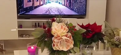 Studio mit Blumenschmuck, Kerze und Nagellackregal